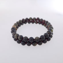 Load image into Gallery viewer, Chakra gemstone bracelet for The Base (Root) Chakra designed by Pellara. Made in Canada. Contains Black Tourmaline, Black Obsidian and Dragon Blood Stone crystals.