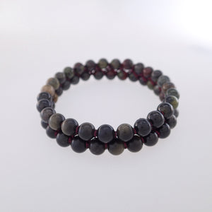 Chakra gemstone bracelet for The Base (Root) Chakra designed by Pellara. Made in Canada. Contains Black Tourmaline, Black Obsidian and Dragon Blood Stone crystals.